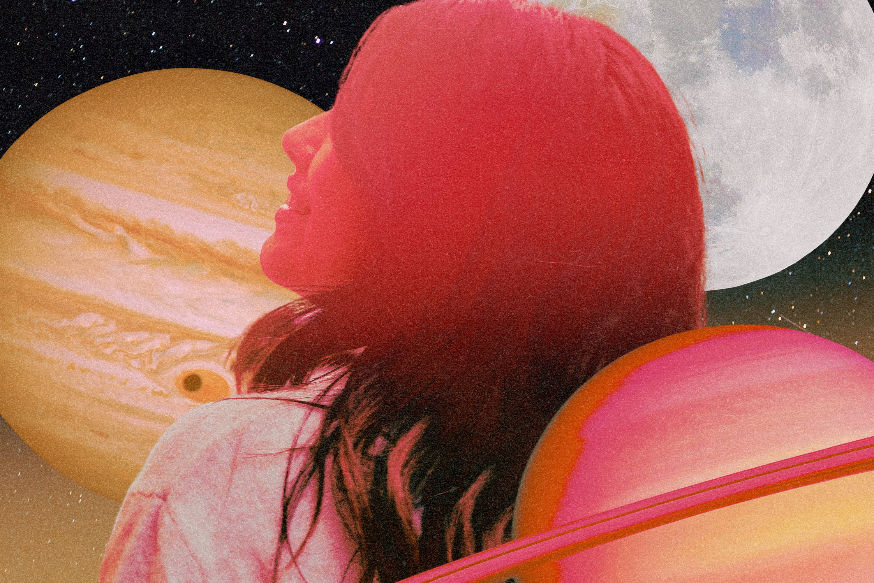 A woman flushed in pink hues smiling in front of a series of planets in the sky